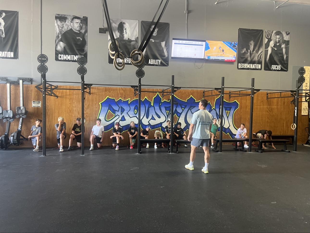 Coach leading a youth fitness class inside CrossFit CrownTown
