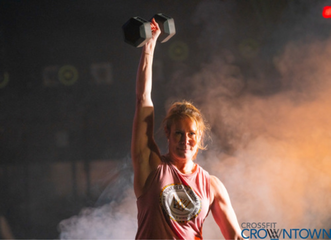 Athlete pressing a dumbbell overhead