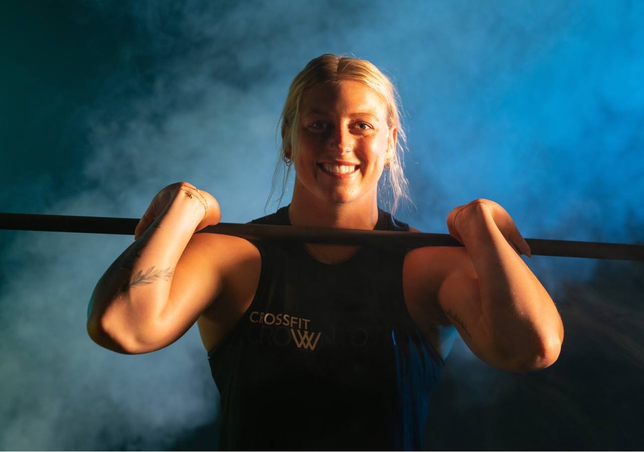 Smiling CrossFit CrownTown athlete in a front-squat stance